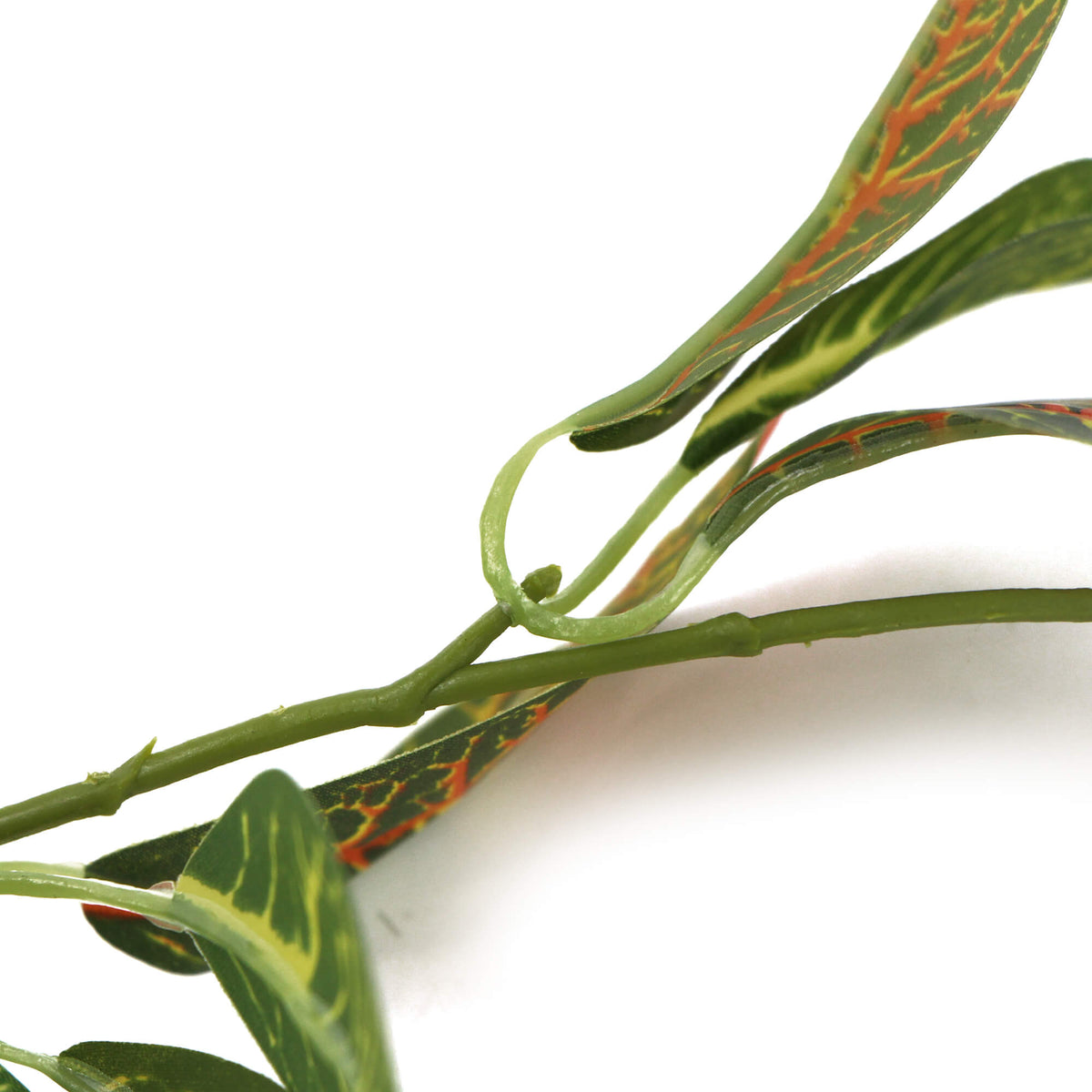 Artificial green leaves with red veins on a white background