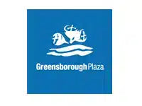 A square blue sign or plaque featuring a white graphic of a castle above the text 'Greensborough Plaza'.