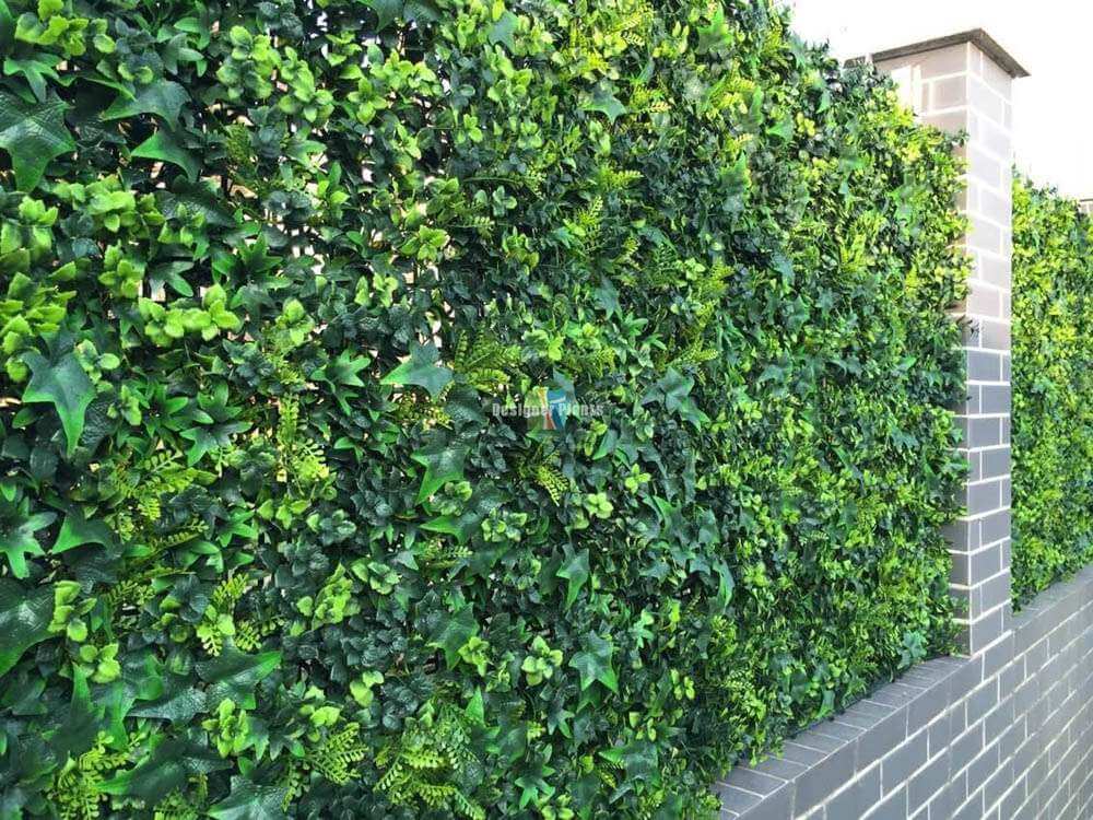 Artificial green wall panel with a gray brick base