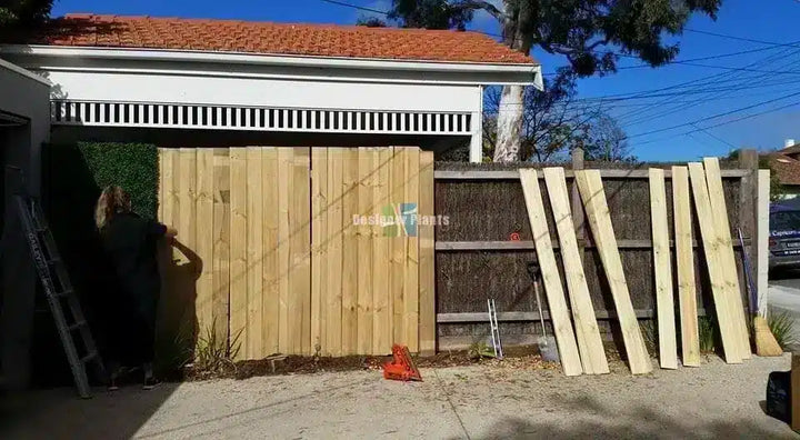 Before – Artificial boxwood hedge panels on a fence in Brighton