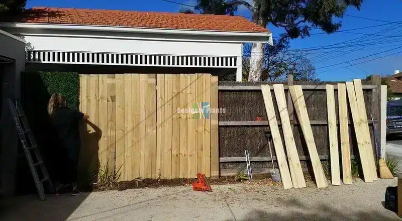 Before – Artificial boxwood hedge panels on a fence in Brighton