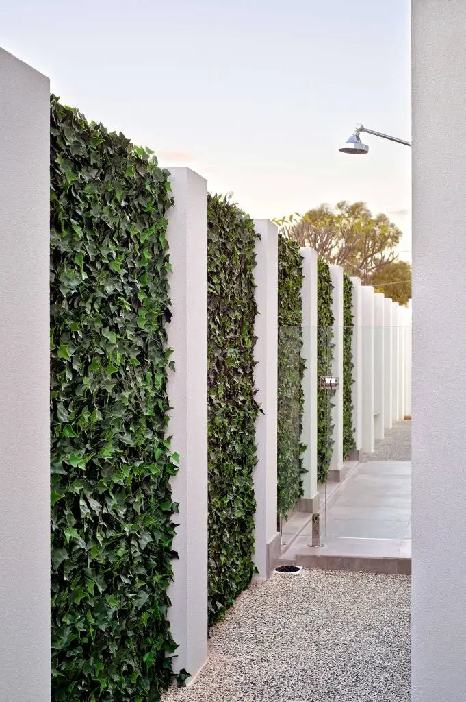 Fake ivy and artificial plants on a pool fence