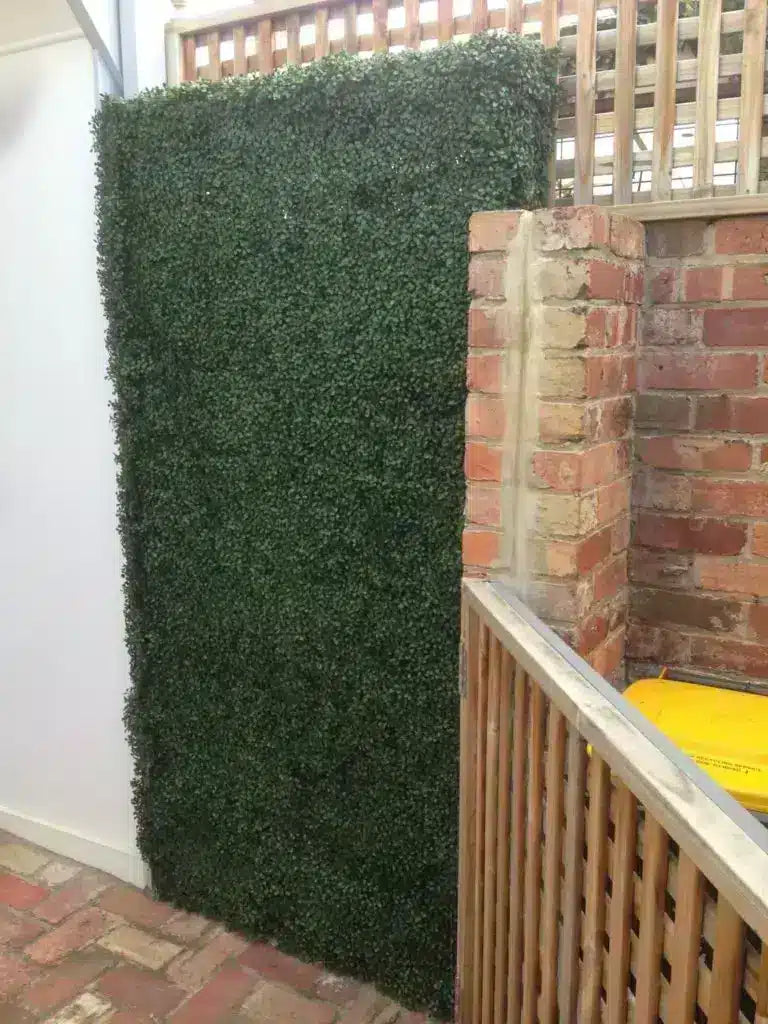 Fake hedge bin cover with boxwood hedge