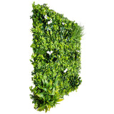 Artificial green wall panel with various types of plants on a white background