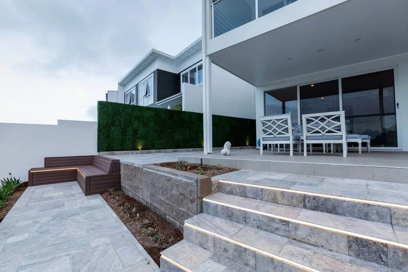 Artificial boxwood panels along a side wall