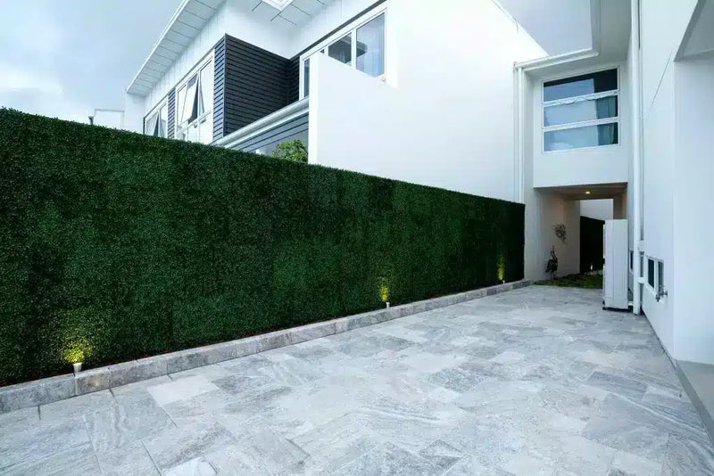 Artificial boxwood panels along a side wall