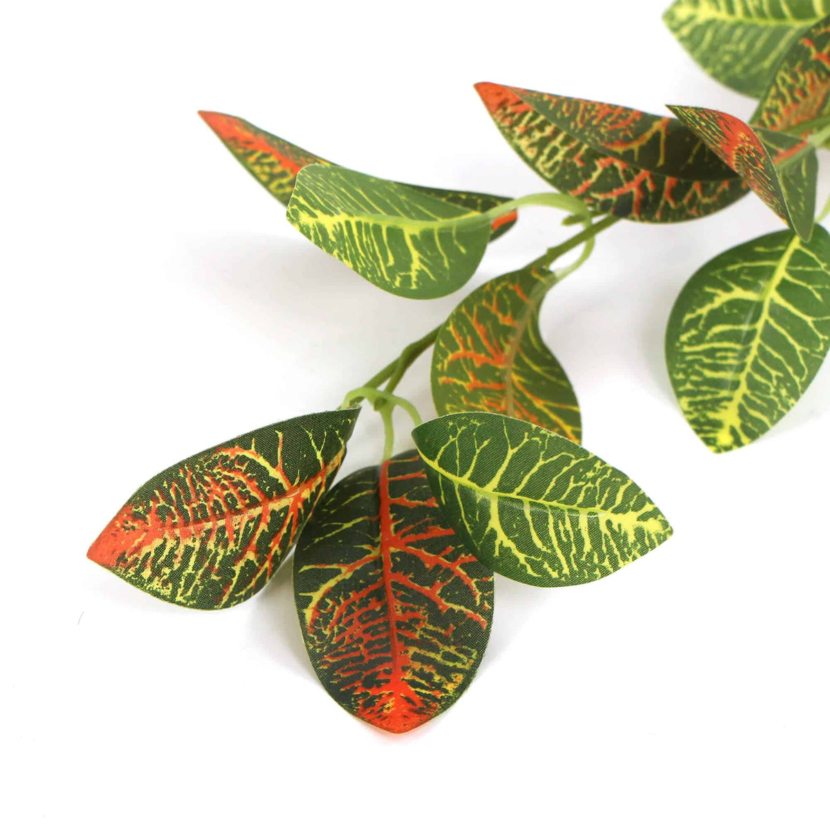 Artificial leaves with green, red, and orange pattern on a white background