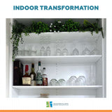 Shelving unit with glasses, bottles, and plants with 'Designer Plants' branding.