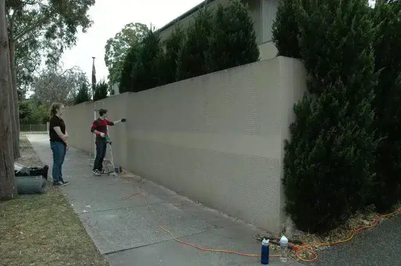 Before -Boxwood screens applied to an external render fence.