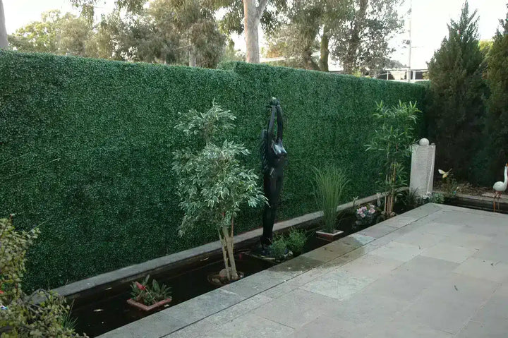 Before – This courtyard previously had a number of artificial plants and a plain render wall.
