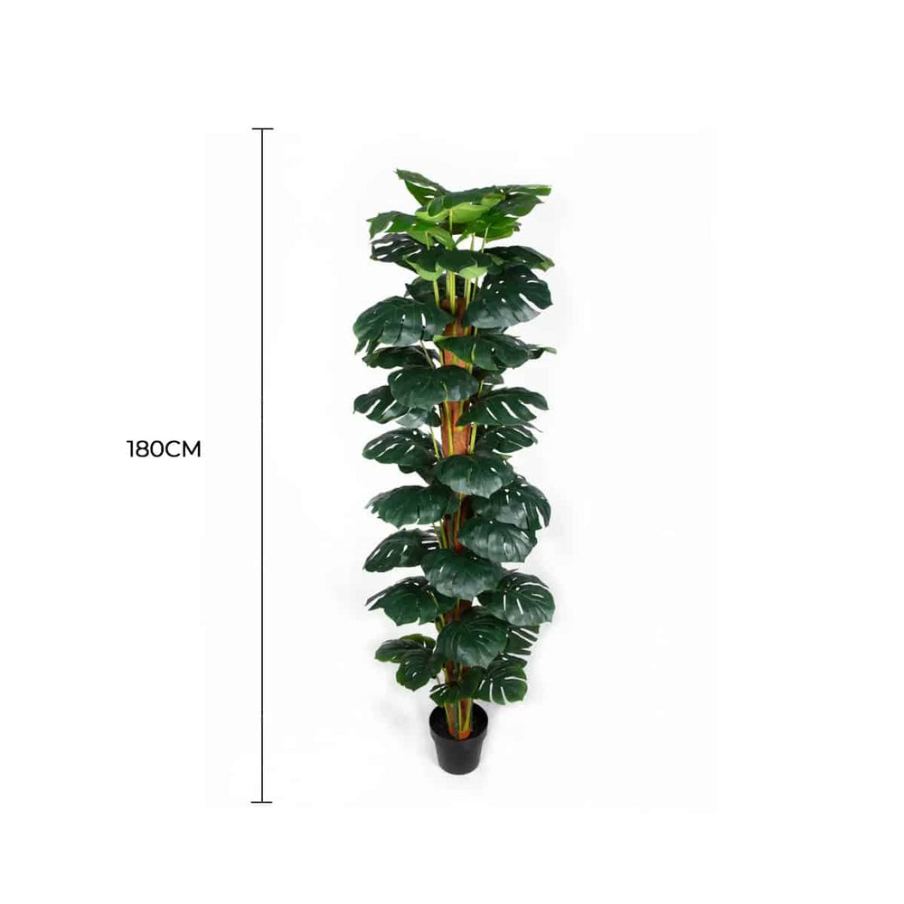 Artificial monstera plant with dimensions on a white background