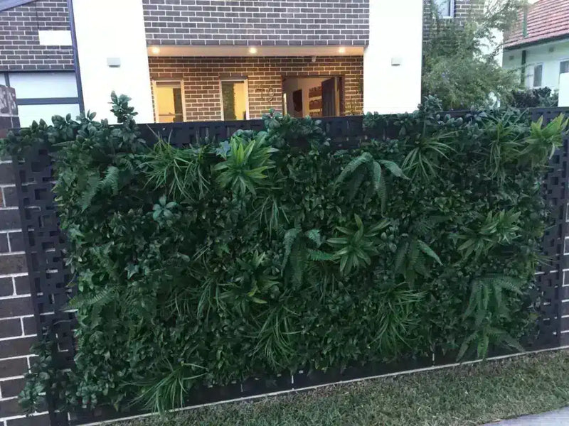 Fake vertical garden on a fence with decorative panels