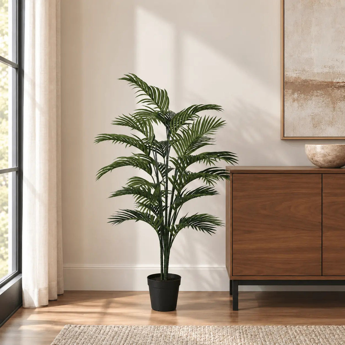 47.2-inch Areca Palm artificial tree in its black nursery pot beside an indoor credenza