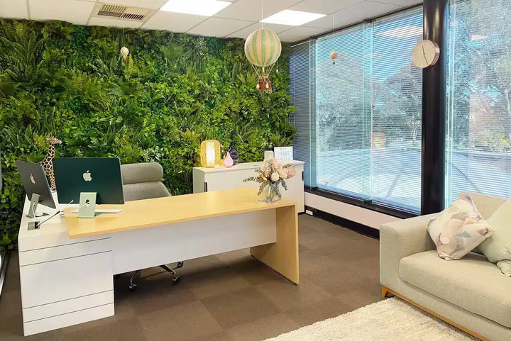 Modern office space with a desk, chairs, and decorative elements.