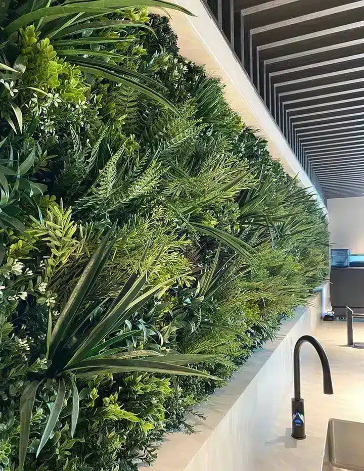 Modern kitchen with a green plant wall and black faucet