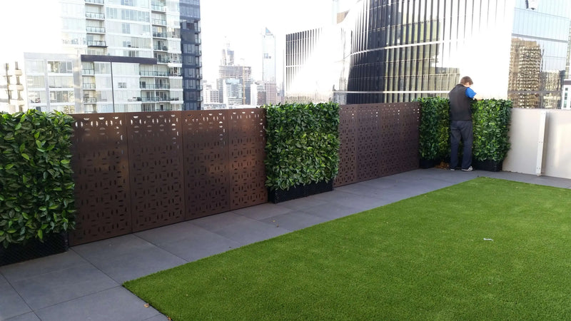 After – Artificial Photinia hedge panels were installed along a balcony wall.