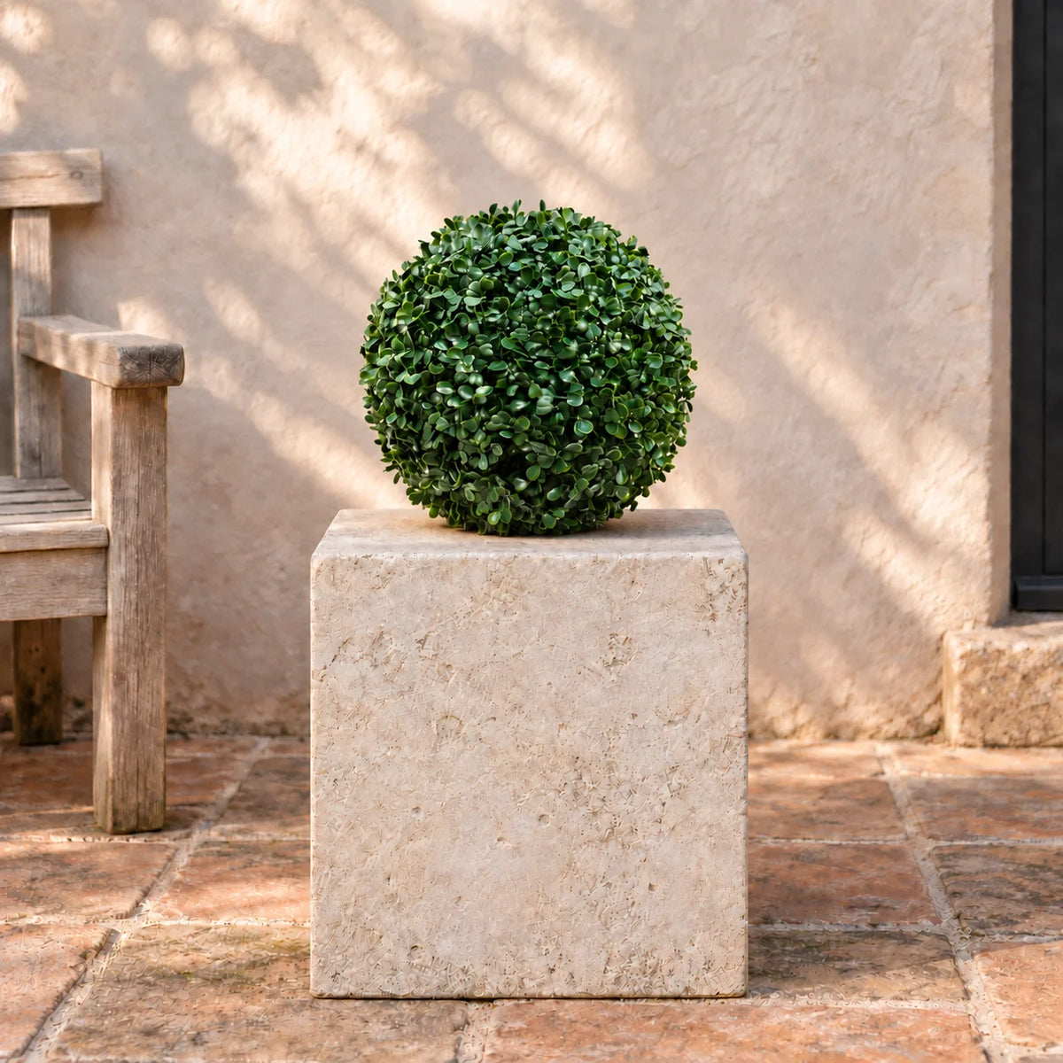 28cm artificial boxwood topiary ball displayed on a stone courtyard plinth.