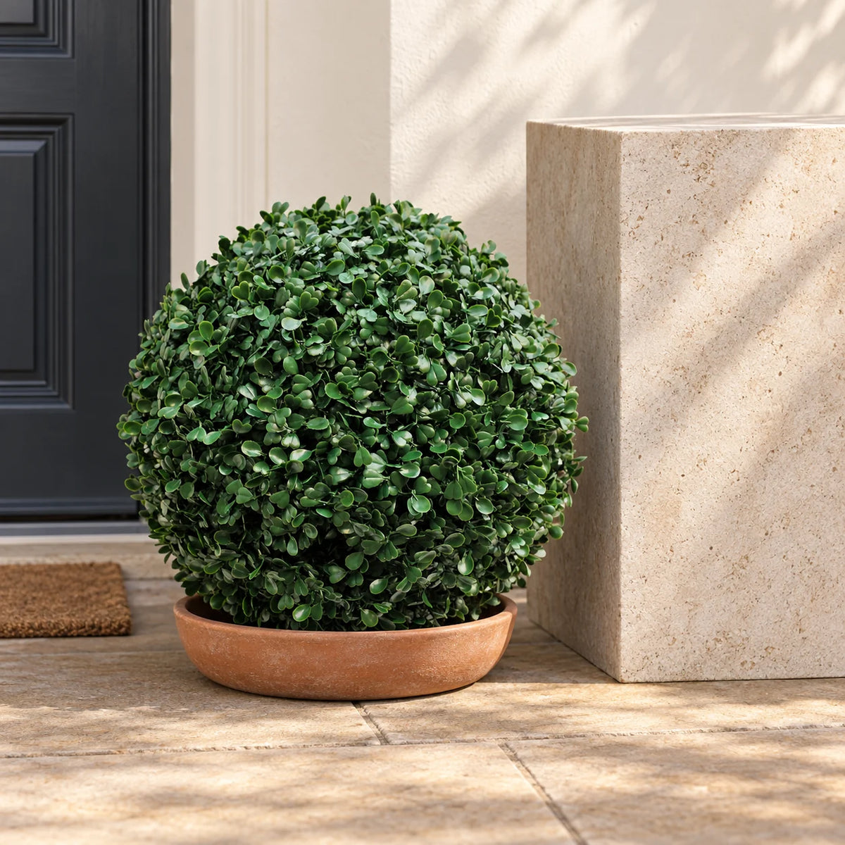 40cm artificial boxwood ball in a low terracotta bowl on a sheltered porch.