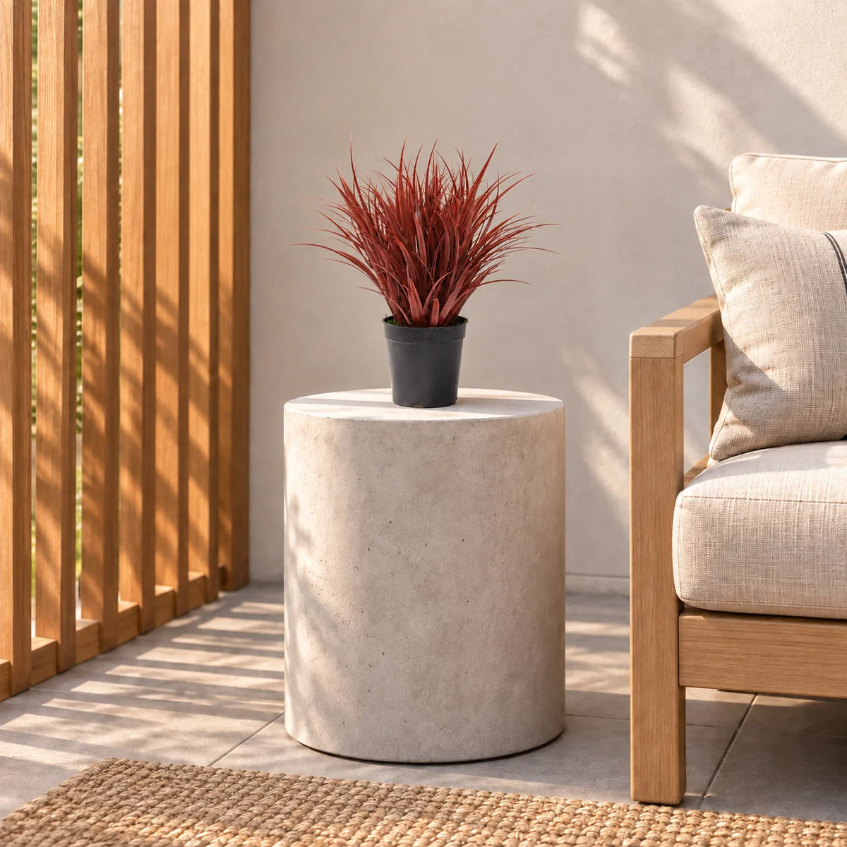 38cm burgundy artificial grass in its black pot on a balcony side table.