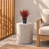 38cm burgundy artificial grass in its black pot on a balcony side table.