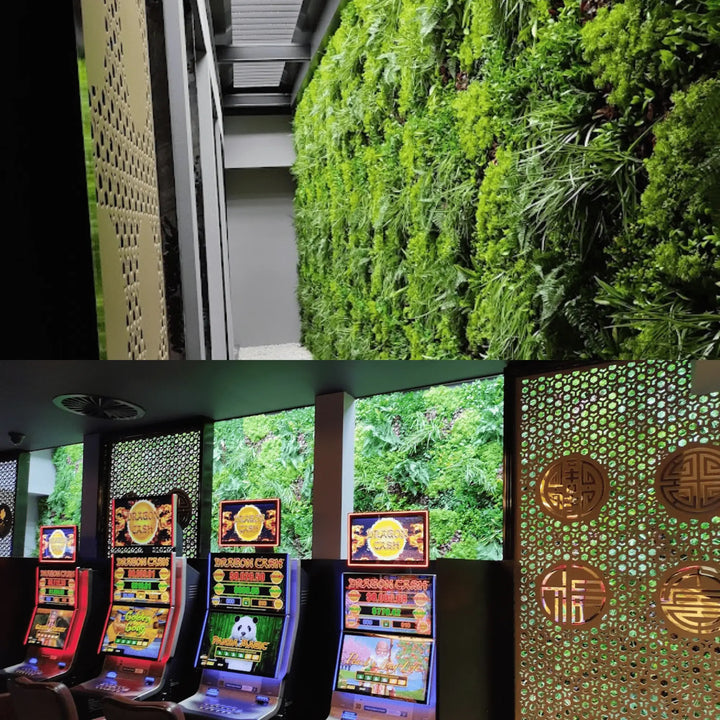 A split image showing a lush green vertical living wall on the top half and several colorful slot machines in a casino interior with decorative gold screens on the bottom half.