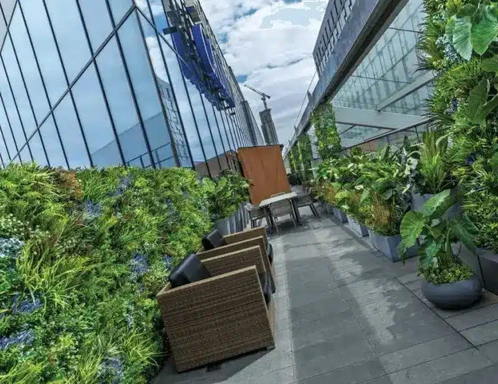 Urban rooftop garden with chairs and plants against a cityscape background