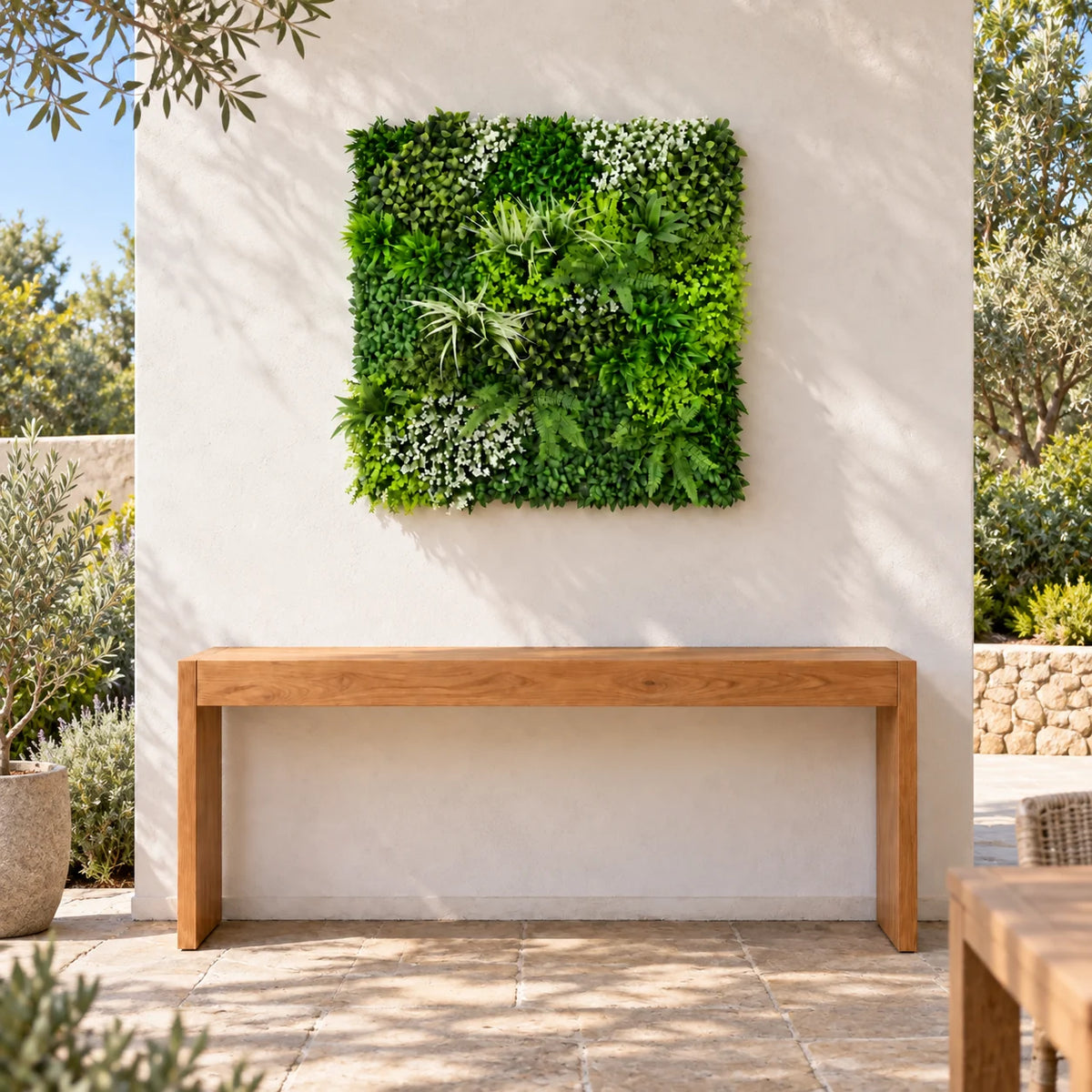 1m square Forest Floor artificial green wall panel above a timber console in an outdoor courtyard.