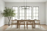 Dining room with wooden table and chairs in a bright room with large windows.