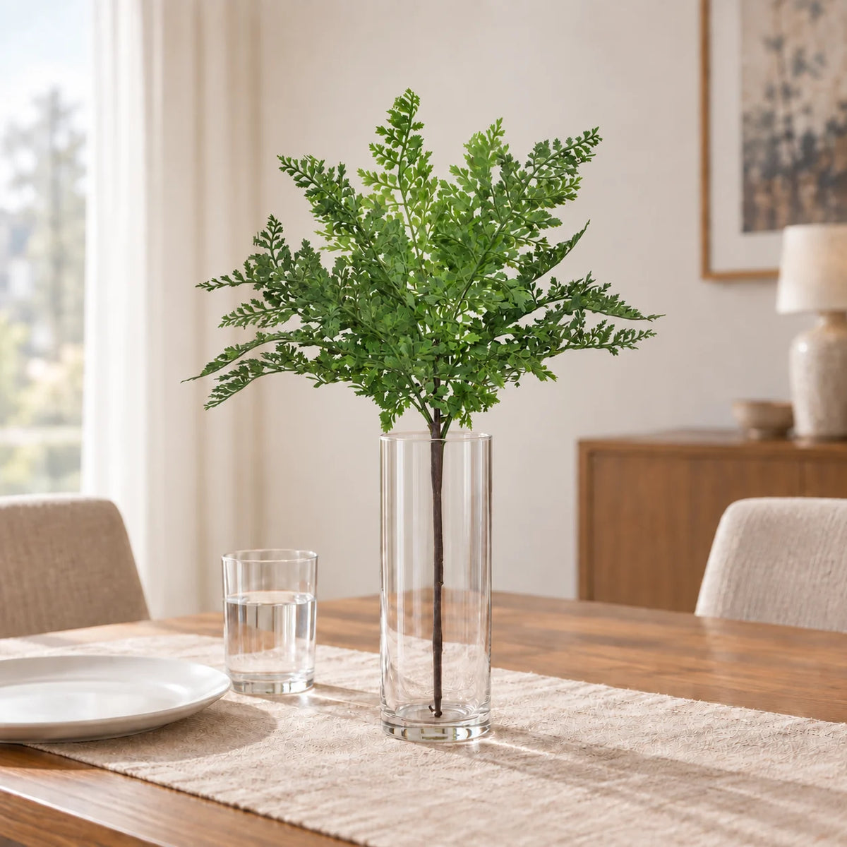 One 40cm artificial maidenhair fern stem in a clear glass vase on a dining table; vase and tableware sold separately.