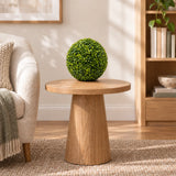 One 28cm mixed boxwood topiary ball styled on a timber side table; furniture shown for styling.