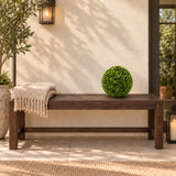 One 28cm mixed boxwood topiary ball on a sheltered terrace bench; furniture shown for styling.