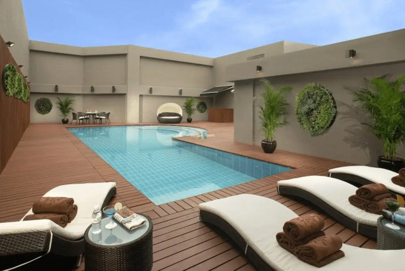 Stunning outdoor entertaining area and pool with fake bamboos and green wall vertical garden