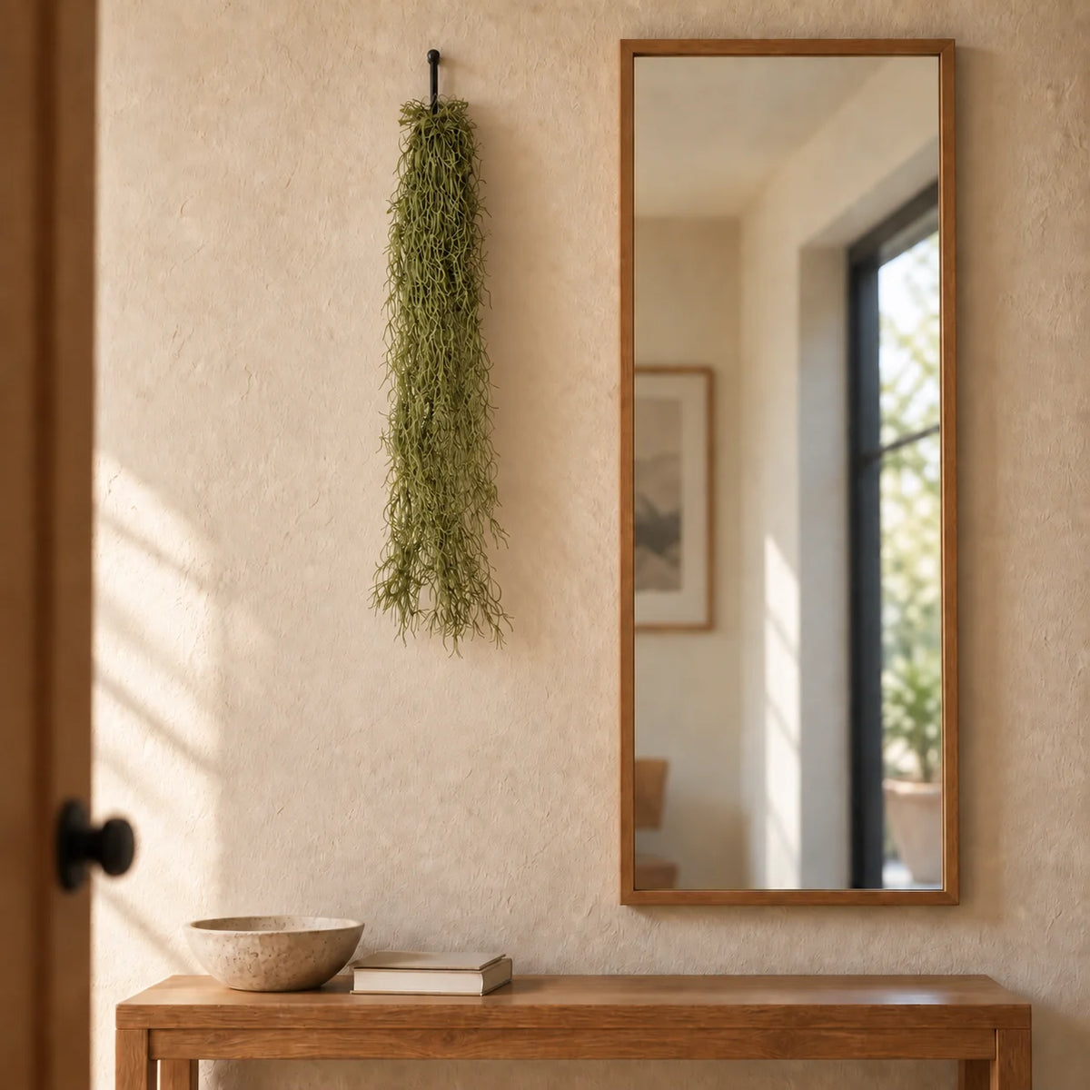 80cm artificial Spanish moss hanging from a discreet wall hook beside an interior mirror.