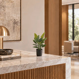 27.6-inch Strelitzia Bird of Paradise artificial plant in its black nursery pot on an indoor reception counter