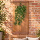 Trailing artificial greenery on a timber wall beside a terrace bench.