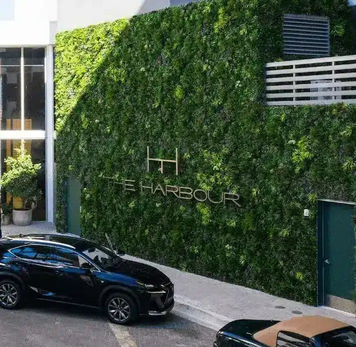 Green wall with 'The Harbour' logo on a building exterior