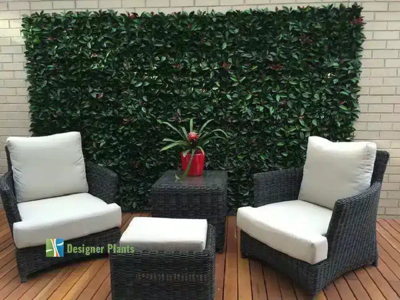 Photinia leaf artificial hedges finish off an empty balcony.
