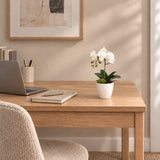 35cm artificial white Phalaenopsis orchid in its supplied decorative pot on a home-office desk; desk accessories shown for styling.