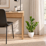 60cm artificial Zanzibar plant in its supplied white pot beside a home-office desk; furniture shown for styling.