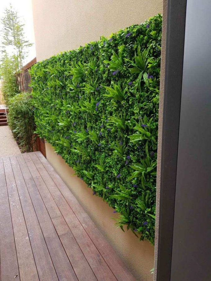 Artificial green wall near a kitchen with fake green walls