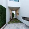 Artificial boxwood panels along a side wall