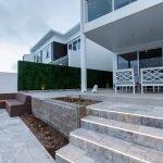 Artificial boxwood panels along a side wall