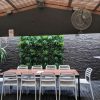 Outdoor cafe and seating area with green tropics on the wall