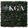 Commercial signage and letters on the back of a green wall panel