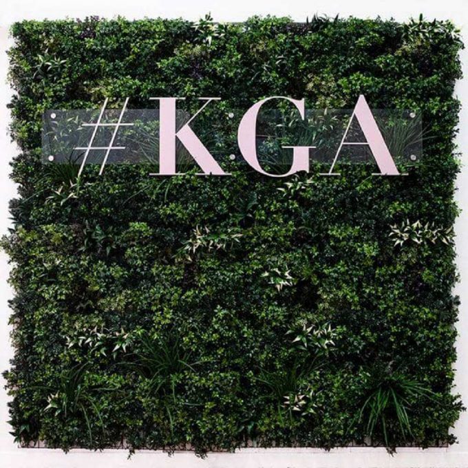 Commercial signage and letters on the back of a green wall panel