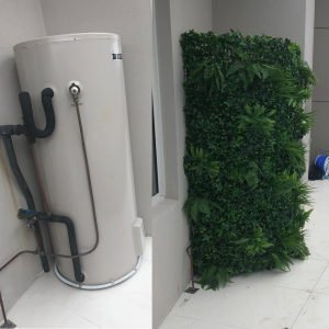 Fake green wall around a water tank