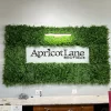 Natural looking Mediterranean Fern panel with a company logo