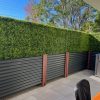 Planter boxes with An Artificial Privacy Hedge Wall Installed