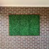 fake hedge panels installed onto brick