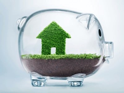 Your guide to a more eco-friendly home - green home with soil and piggy bank